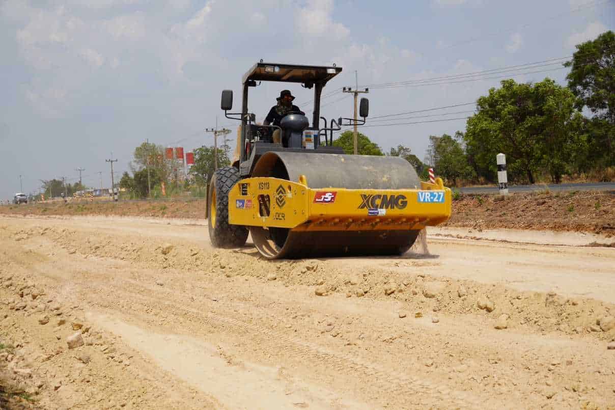 Construction worker operating a soil compaction machine on site